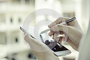 A woman using tablet with stylus pen photo